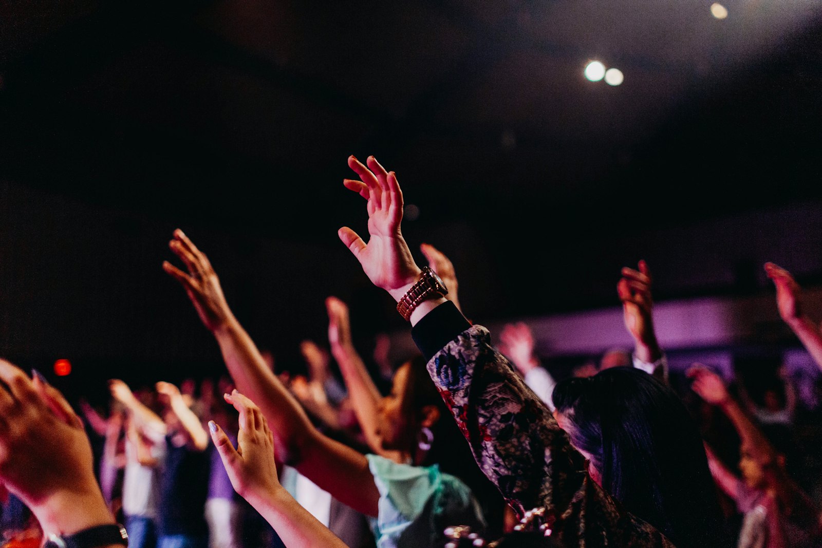A congregation with hands raised during a service
